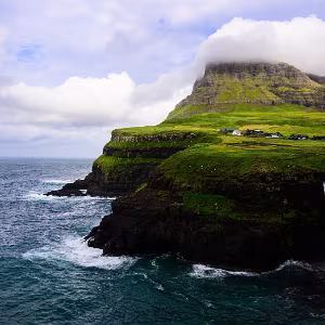 Føroyar Quiet landscapes from the Faroe Islands, shaped by weather, scale, and isolation.